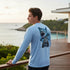 Sea Fear light blue long sleeve performance tee with a detailed Megalodon shark graphic on the back, worn by a man.